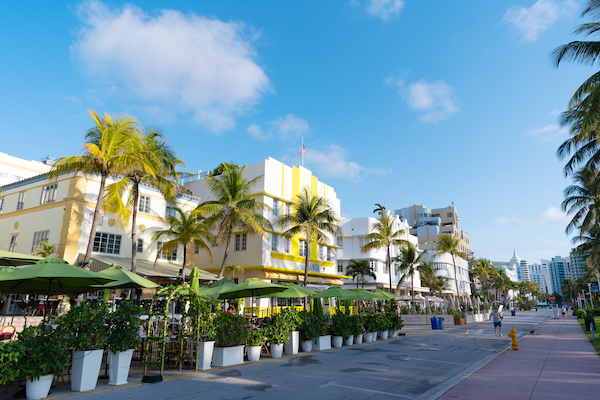 Miami, USA – April 15, 2021: South Beach sidewalk cafes and hotels line Ocean Drive in Florida